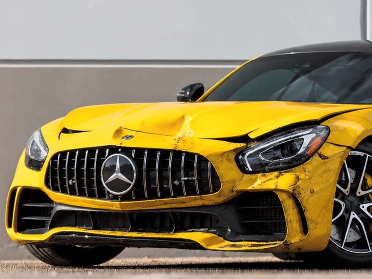 Yellow Mercedes-AMG GT R with collision damage to the front bumper, fender and headlight